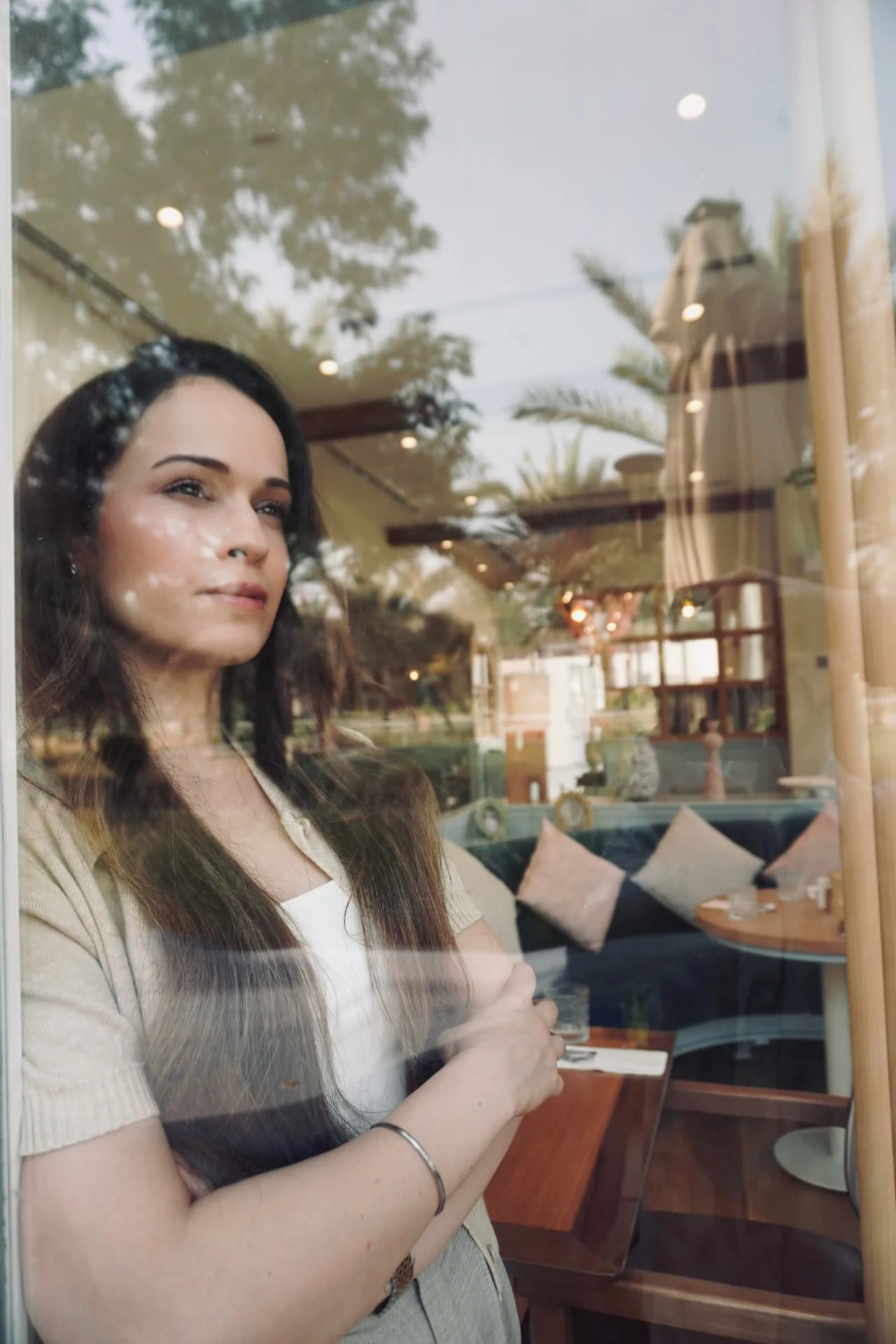 Komel Kaur looking out through a cafe window